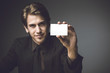Photo: Young man presenting a businesss card Young man presenting a businesss card
