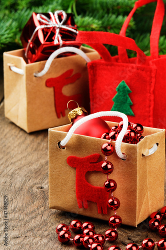 Photo: Christmas presents next to festive fir tree Christmas presents next to festive fir tree
