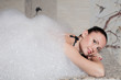Young woman having massage in hamam.