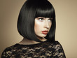 Fashion portrait of a young beautiful dark-haired woman