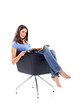 Casual 20s women sitting with magazine, looking to camera