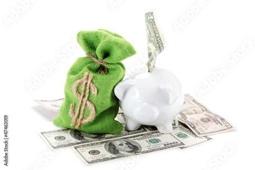 Photo: Piggy bank on the bills of American dollars isolated against whi Piggy bank on the bills of American dollars isolated against whi