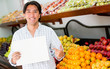 Man with an open sign at his business