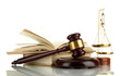 Golden scales of justice, gavel and books isolated on white