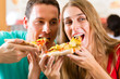 Photo: Mann und Frau essen eine Pizza Mann und Frau essen eine Pizza