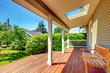Photo: Large covered porch with skylight and wood bench and floor. Large covered porch with skylight and wood bench and floor.