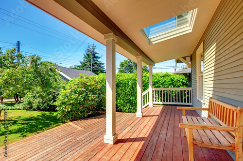 Photo: Large covered porch with skylight and wood bench and floor. Large covered porch with skylight and wood bench and floor.