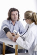 Doctor checks patient's pressure