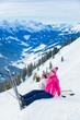 Young skier sitting on the hill