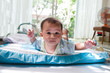 Photo: baby lied on bed in home living room baby lied on bed in home living room