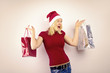beautiful blonde woman holding a christmas gift is smiling