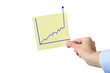 Hand holding paper with rising chart
