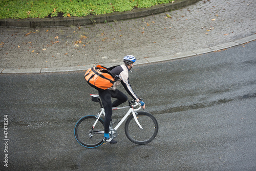 Photo: Male Cyclist With Backpack On Street Male Cyclist With Backpack On Street