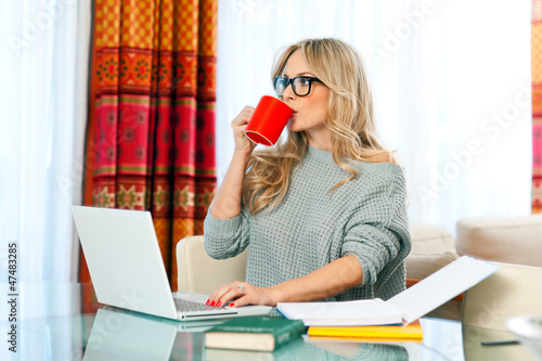 Photo: woman working on laptop at home woman working on laptop at home