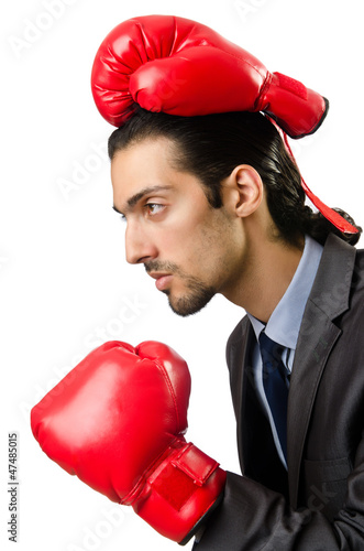 Photo: Businessman with boxing gloves on white Businessman with boxing gloves on white
