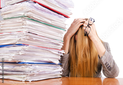 Photo: Busy woman with stacks of paper Busy woman with stacks of paper