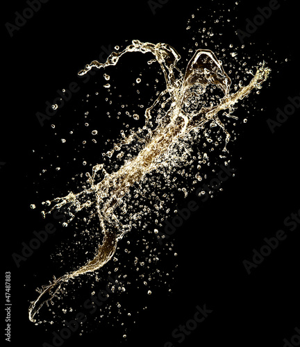 Photo: Champagne splash isolated on black background Champagne splash isolated on black background