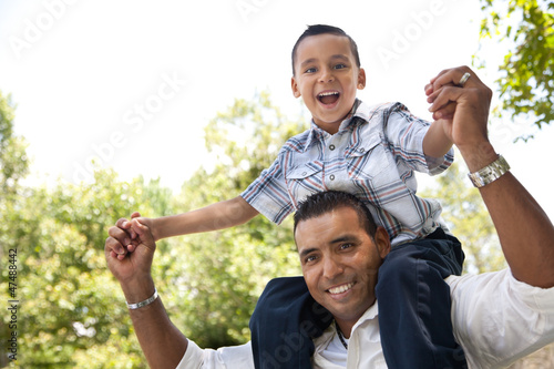 Photo: Hispanic Father and Son Having Fun in the Park Hispanic Father and Son Having Fun in the Park
