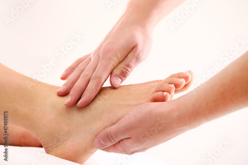 Photo: Enjoying and relaxing foot massage close up Enjoying and relaxing foot massage close up