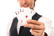 Handsome young man holding playing cards