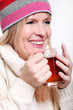 Mid age Woman With Hot tea Wearing Winter Clothes