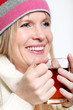 Mid age Woman With Hot tea Wearing Winter Clothes