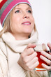 Mid age Woman With Hot tea Wearing Winter Clothes