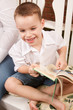 Cute Young Boy Reading His Book
