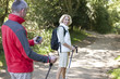 A mature couple walking, navigating with a smartphone