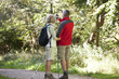 A mature couple walking, navigating with a smartphone