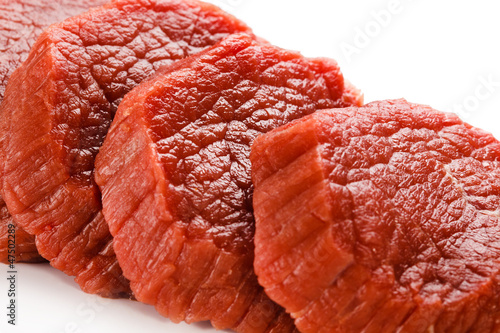 Photo: Raw beef on white background Raw beef on white background