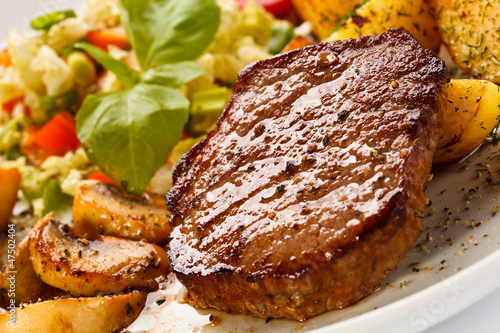 Photo: Grilled steak, baked potatoes and vegetables Grilled steak, baked potatoes and vegetables