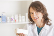 Photo: Young woman pharmacist with a bottle of drugs Young woman pharmacist with a bottle of drugs