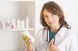 Photo: Young woman pharmacist or doctor with a bottle of drugs Young woman pharmacist or doctor with a bottle of drugs