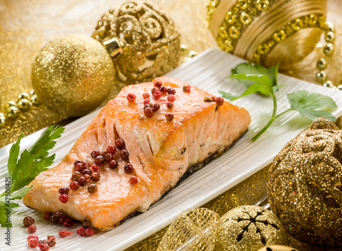Photo: grilled salmon with pink pepper on christmas table grilled salmon with pink pepper on christmas table