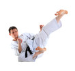 Photo: Karate jump against white background Karate jump against white background