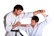 Photo: Karate. Men in a kimono with a white background Karate. Men in a kimono with a white background