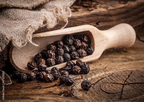 Photo: Black pepper on the rustic old wooden table Black pepper on the rustic old wooden table