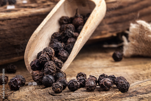 Photo: Black pepper on the rustic old wooden table Black pepper on the rustic old wooden table