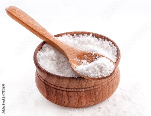 Photo: Sea Salt in a spoon and bowl isolated on white background Sea Salt in a spoon and bowl isolated on white background