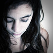 Portrait of a sad hispanic girl with a slight bue toning