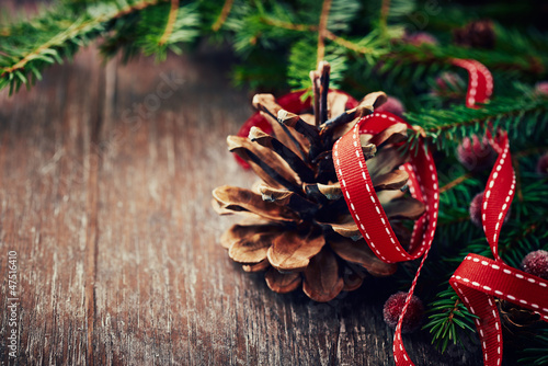 Photo: Rustic christmas decoration with spruce twigs and pine cone Rustic christmas decoration with spruce twigs and pine cone