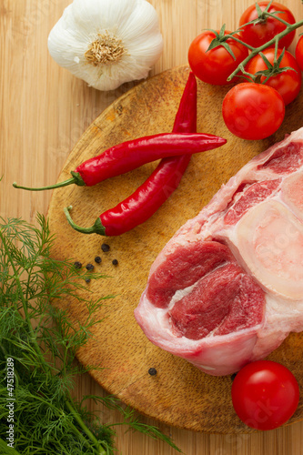 Photo: Raw oxtail with ingredients on cut board Raw oxtail with ingredients on cut board
