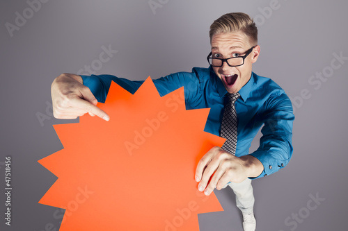 Photo: Enthusiastic salesman pointing at empty sign with space for text Enthusiastic salesman pointing at empty sign with space for text