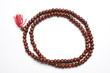 Prayer beads made from sandalwood in a white background