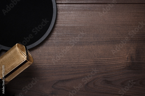 Photo: vintage condensing microphone and pop filter over wooden backgro vintage condensing microphone and pop filter over wooden backgro