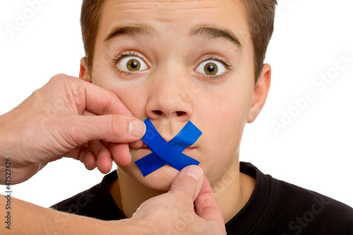 Photo: Junge bekommt Redeverbot - Pflaster, Klebesteifen über dem Mund Junge bekommt Redeverbot - Pflaster, Klebesteifen über dem Mund
