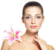 Beauty face of young woman with flower. Beauty treatment concept
