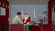 Santa Claus signing a contract with a Businessman