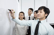 Chinese Business man writing on whiteboard
